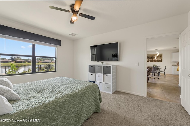 bedroom featuring visible vents, baseboards, ceiling fan, tile patterned flooring, and carpet flooring