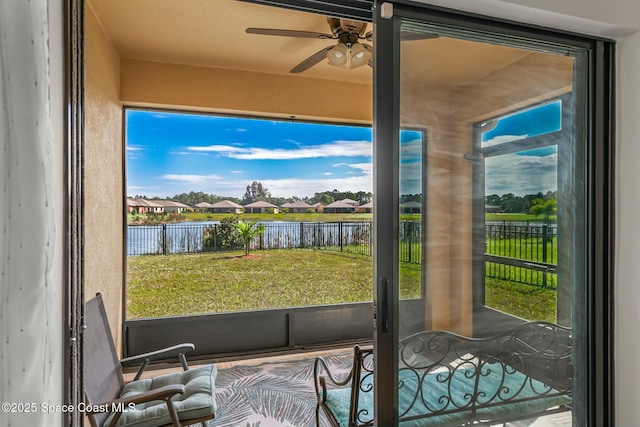 entryway featuring a residential view, a water view, and ceiling fan