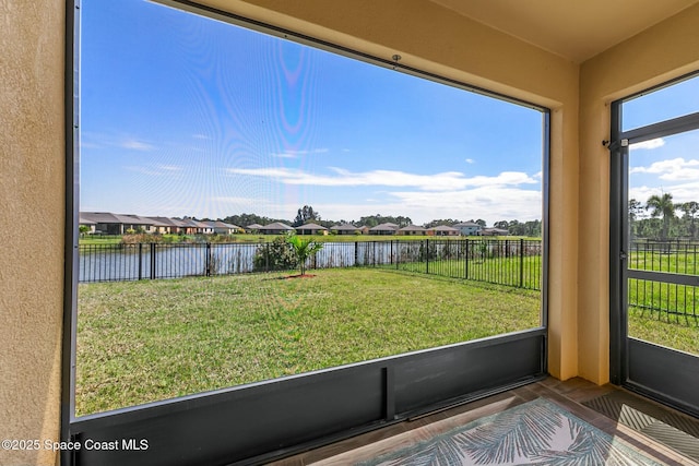 unfurnished sunroom featuring a water view