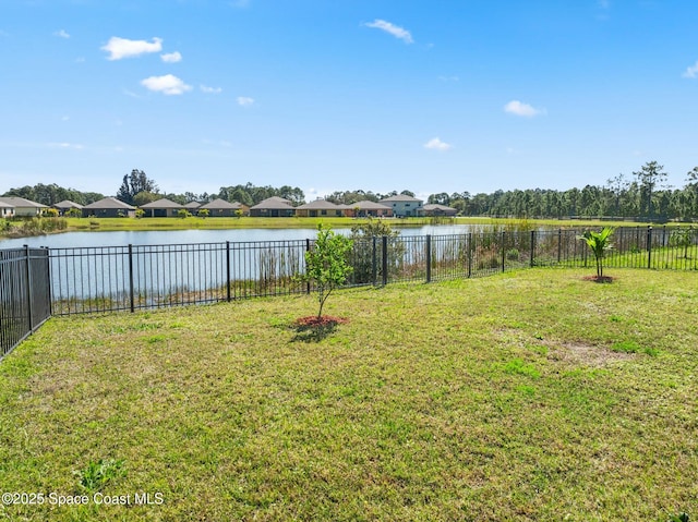 view of yard featuring a water view and a fenced backyard