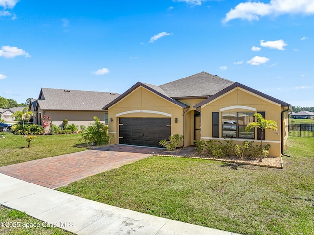 ranch-style home with an attached garage, roof with shingles, decorative driveway, stucco siding, and a front yard