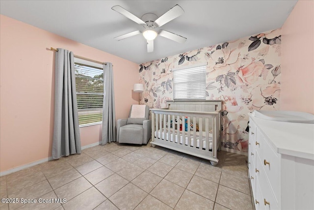 unfurnished bedroom featuring light tile patterned floors, multiple windows, and baseboards