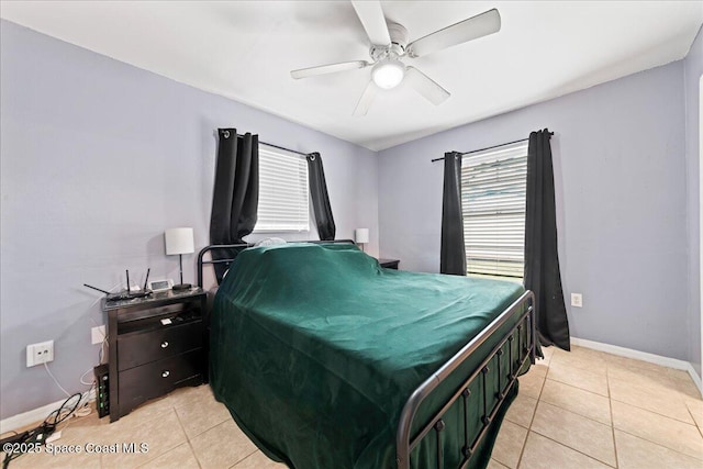 bedroom featuring baseboards, a ceiling fan, and light tile patterned flooring