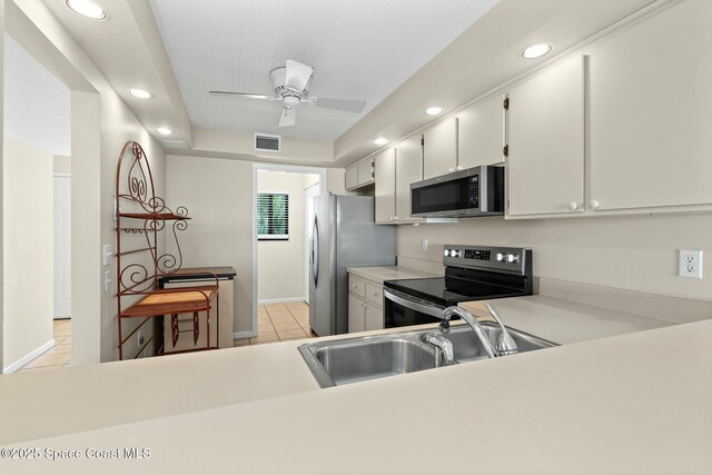 kitchen featuring visible vents, appliances with stainless steel finishes, light countertops, a sink, and light tile patterned flooring