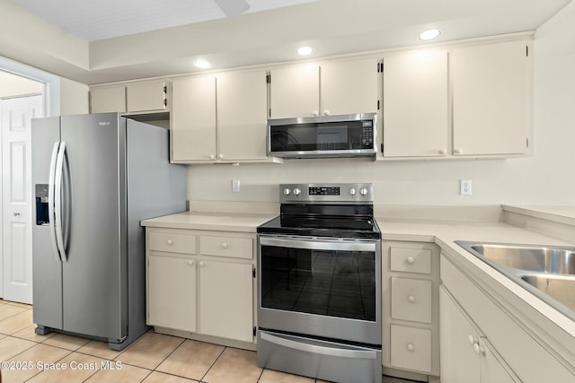 kitchen with recessed lighting, appliances with stainless steel finishes, light countertops, and light tile patterned flooring