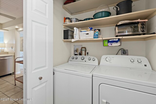 washroom featuring laundry area, light tile patterned floors, and washer and dryer