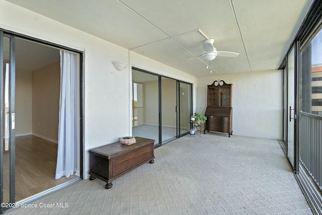 sunroom featuring a ceiling fan