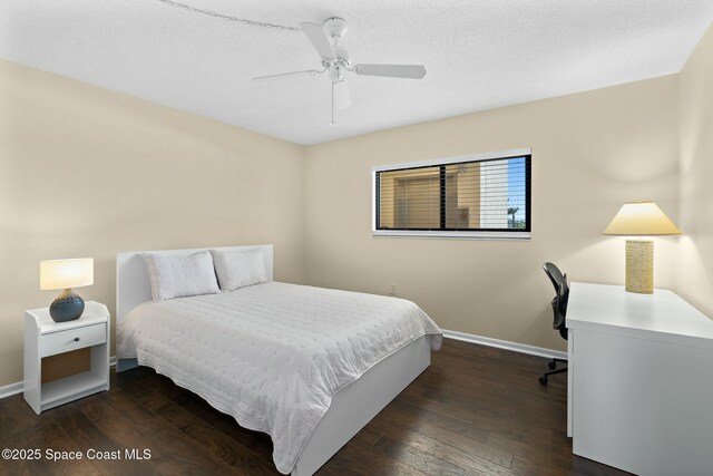 bedroom with a ceiling fan, a textured ceiling, baseboards, and wood finished floors