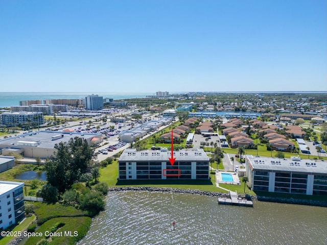 birds eye view of property with a view of city and a water view