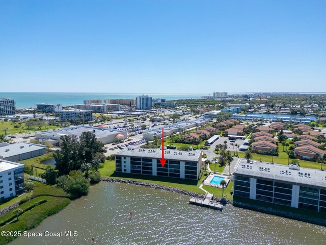 birds eye view of property featuring a water view and a city view