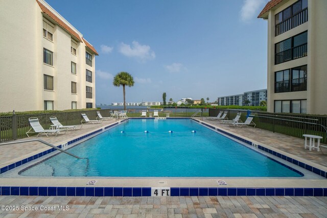 community pool featuring a patio area and fence