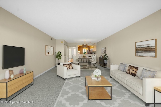 living area with carpet floors, baseboards, and visible vents