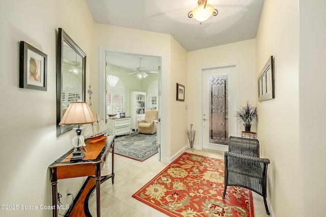 doorway to outside with light tile patterned floors, baseboards, and arched walkways