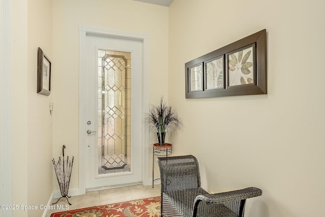 doorway to outside with baseboards and light tile patterned flooring