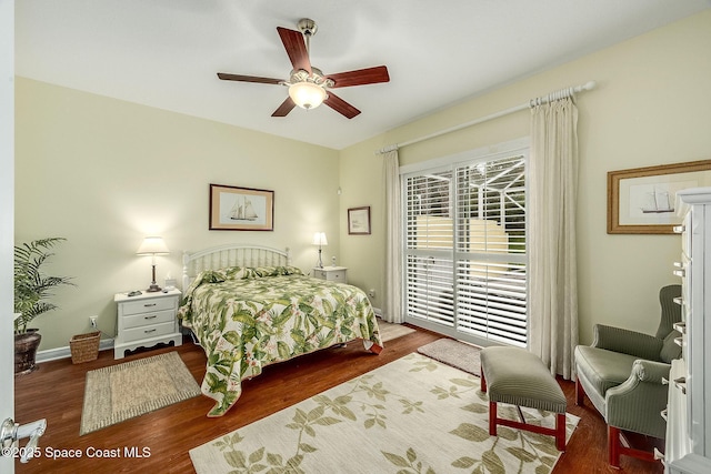 bedroom featuring baseboards, wood finished floors, access to exterior, and a ceiling fan