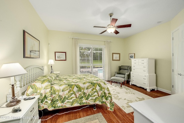 bedroom with ceiling fan, baseboards, wood finished floors, and access to outside