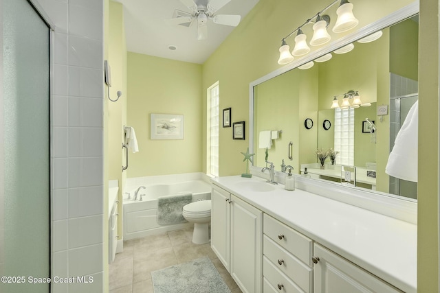 full bathroom featuring tile patterned flooring, ceiling fan, a garden tub, a stall shower, and vanity