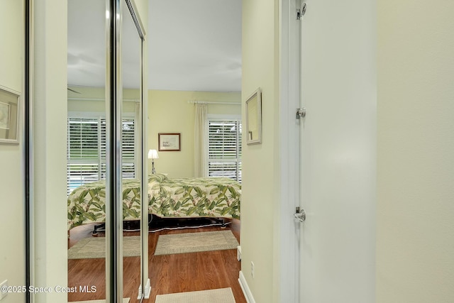 hall with wood finished floors and baseboards