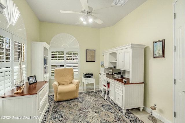 home office with light tile patterned flooring, baseboards, visible vents, and ceiling fan