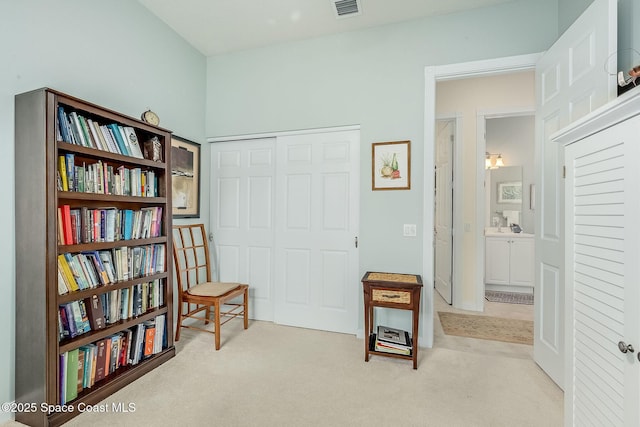 living area with visible vents and carpet floors