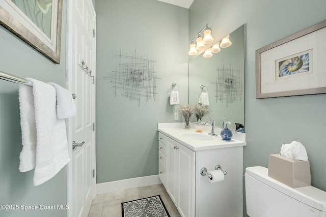 bathroom featuring vanity, tile patterned floors, toilet, and baseboards