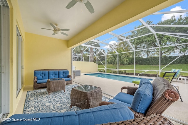 outdoor pool featuring glass enclosure, an outdoor living space, ceiling fan, a patio area, and a lawn