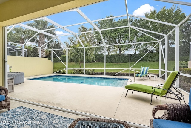 outdoor pool with a patio area, glass enclosure, and a lawn