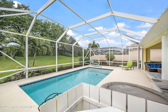 pool featuring a patio, a lawn, and a lanai