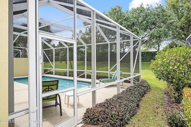 outdoor pool featuring glass enclosure, a patio area, and a lawn