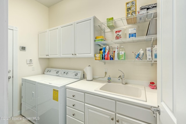 laundry room with a sink, cabinet space, and washing machine and clothes dryer