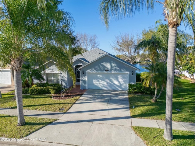 ranch-style home with a shingled roof, an attached garage, driveway, and a front lawn