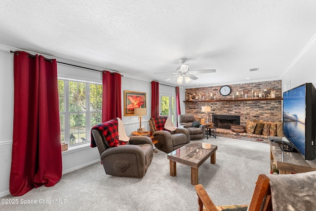 carpeted living area featuring crown molding, a fireplace, visible vents, and a healthy amount of sunlight