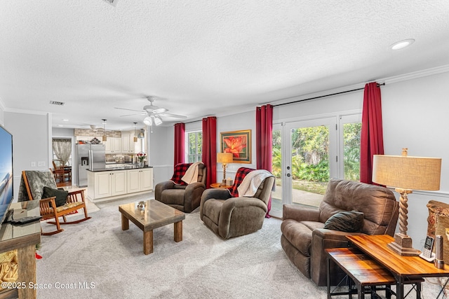 living room featuring recessed lighting, light colored carpet, crown molding, and a textured ceiling