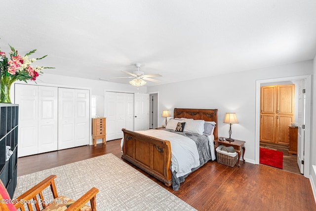 bedroom with multiple closets, a ceiling fan, baseboards, and wood finished floors