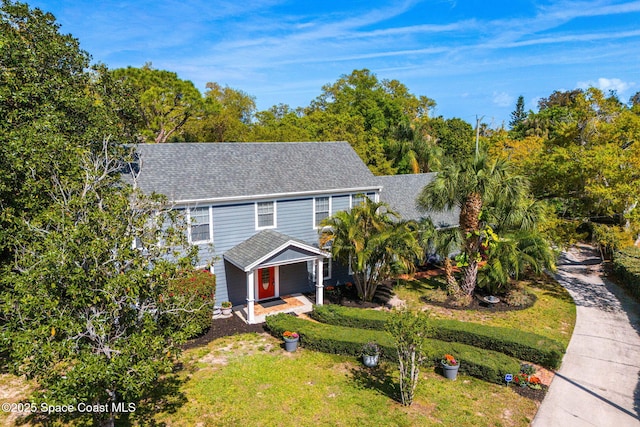 4230 Overhill Dr, Merritt Island, FL 32952 - view of front facade featuring a front lawn and a shingled roof