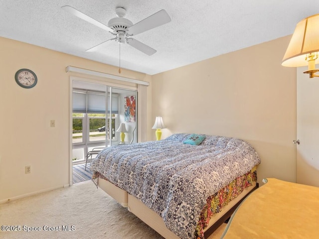 bedroom featuring a textured ceiling, ceiling fan, carpet, and baseboards