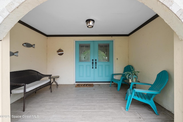 doorway to property with french doors and stucco siding