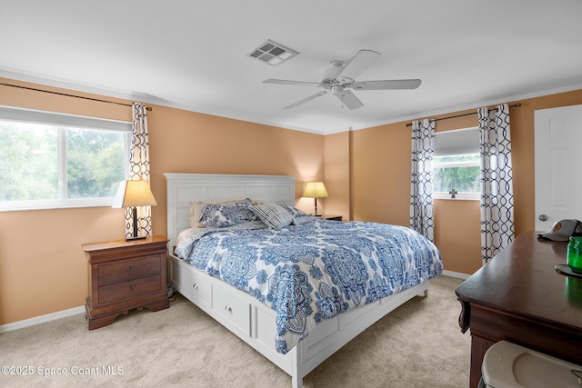 bedroom featuring baseboards, visible vents, a ceiling fan, and light colored carpet