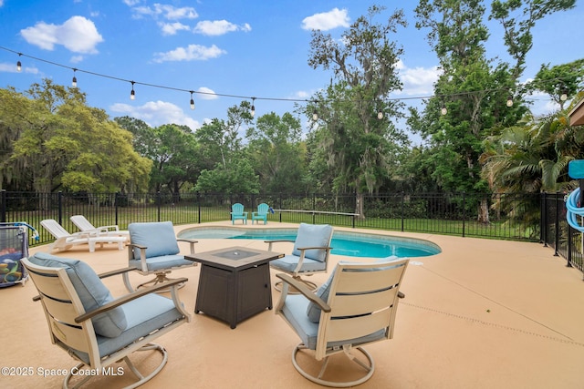 view of pool with an outdoor fire pit, fence, a fenced in pool, and a patio