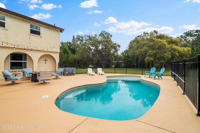 view of pool with a fenced in pool, a patio, and fence