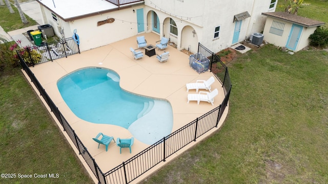 view of pool featuring a fenced in pool, a lawn, a patio, fence, and cooling unit