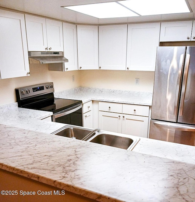 kitchen with appliances with stainless steel finishes, a sink, white cabinetry, and under cabinet range hood