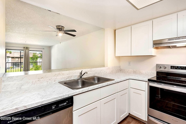 kitchen with white cabinets, under cabinet range hood, stainless steel appliances, and a sink