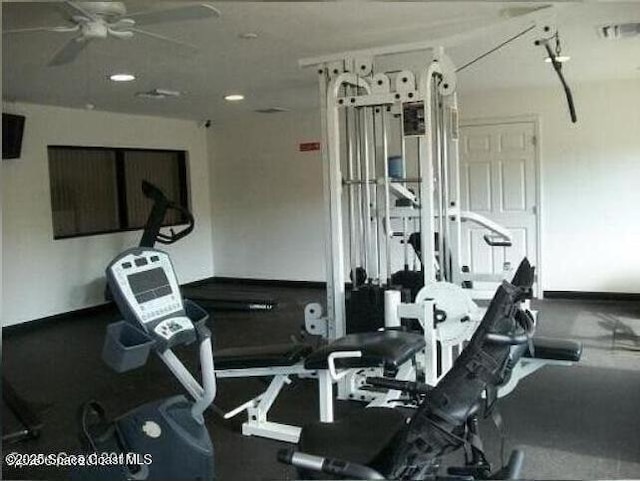 gym with baseboards and a ceiling fan