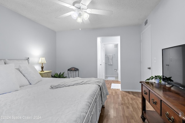 bedroom with visible vents, ceiling fan, light wood-style flooring, and a textured ceiling