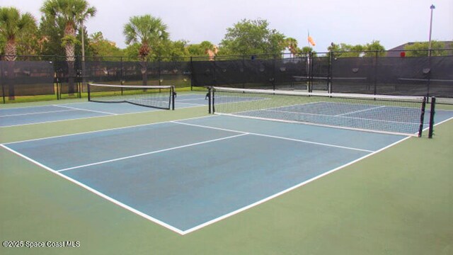 view of tennis court with fence