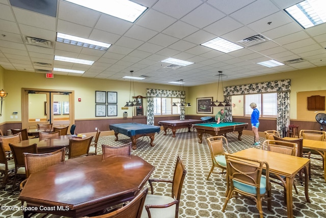 rec room featuring wainscoting, plenty of natural light, and visible vents