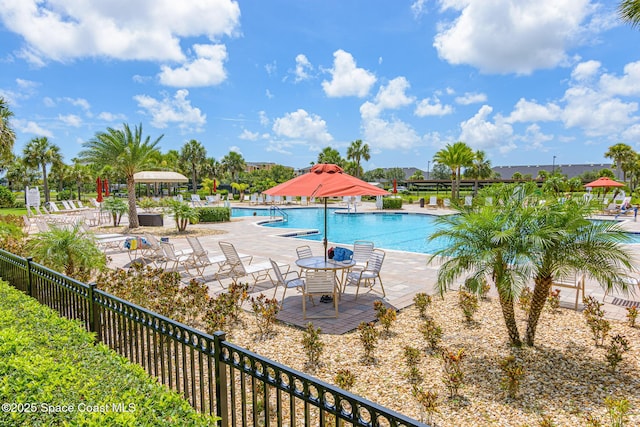 pool featuring a patio area and fence