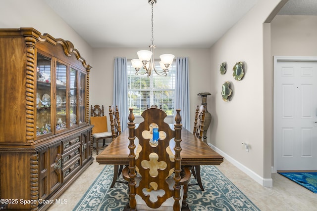 dining room featuring light tile patterned floors, baseboards, a chandelier, and arched walkways