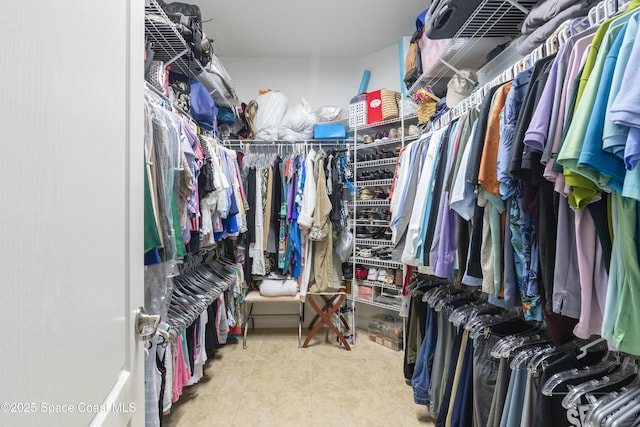 walk in closet with tile patterned floors